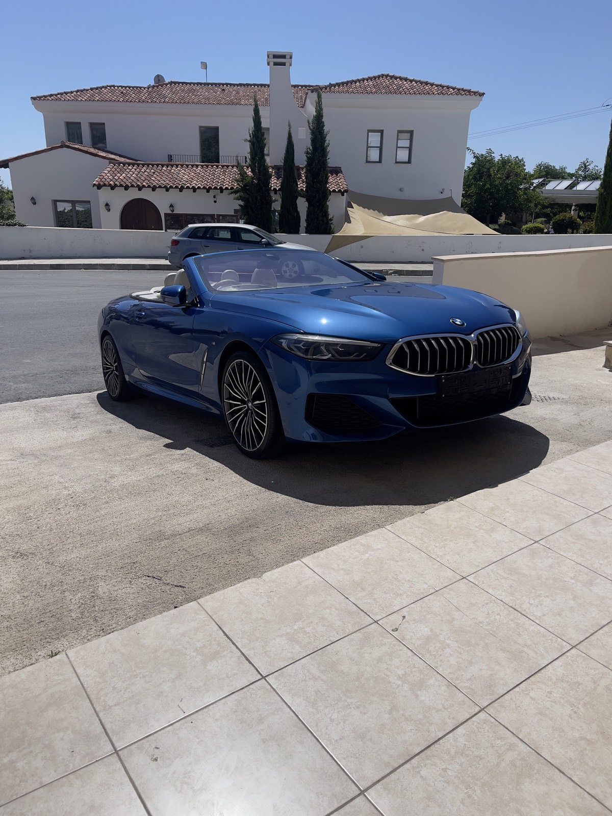 Ceramic-coated blue BMW 8 Series convertible parked in driveway, PG Detailing