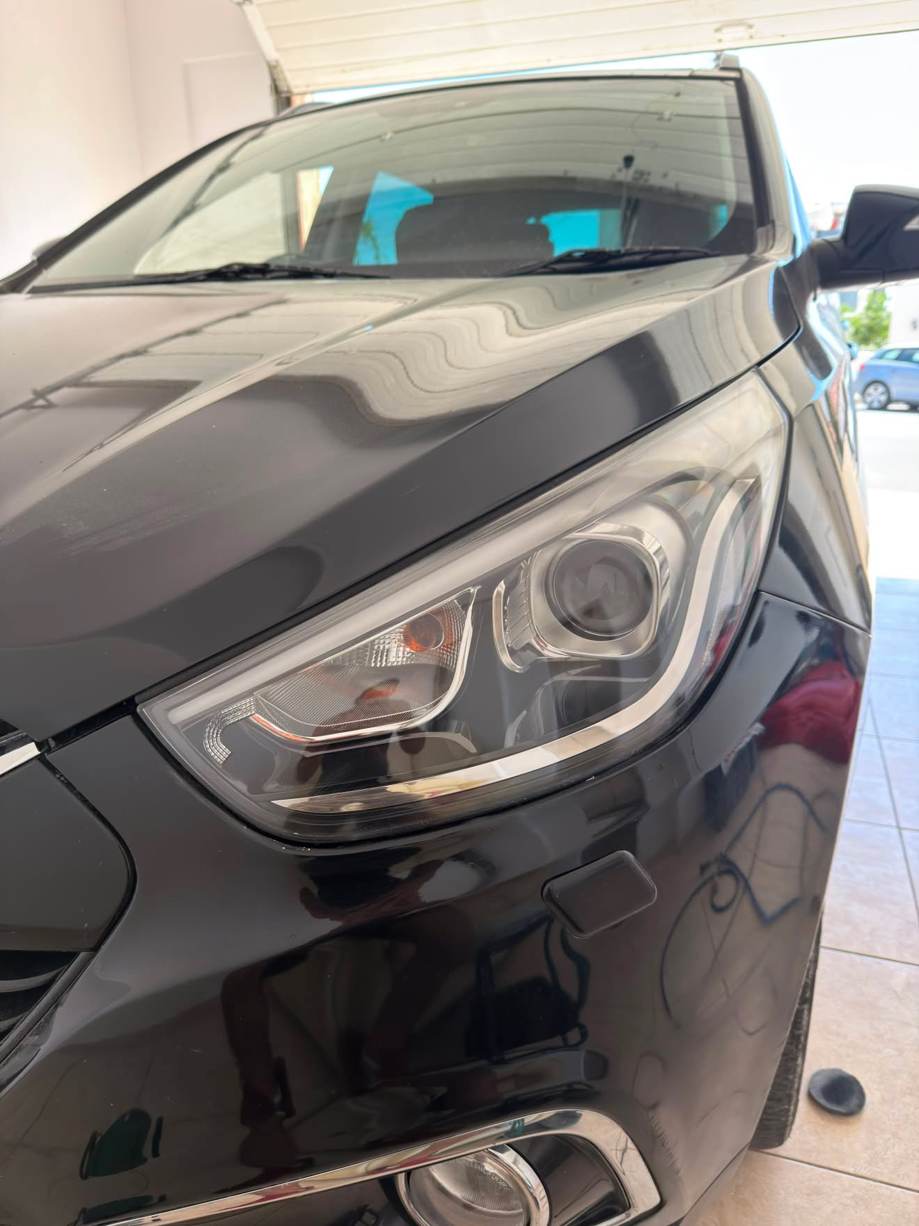 Restored clear headlight lens after wet-sanding and polish